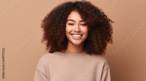 A radiant teenage girl exudes happiness against a soft  neutral studio backdrop.
