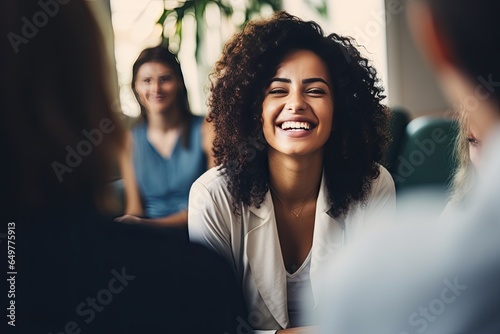 Group therapy and support. The focus is on a young African American woman. A group of people around support her. She is happy.