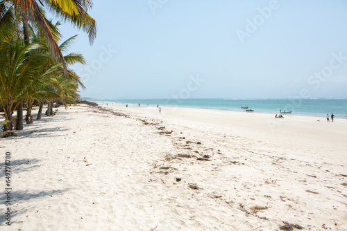 Paradise beach with white sand and palms. Diani Beach at Indian ocean surroundings of Mombasa  Kenya. Landscape photo exotic beach in Africa