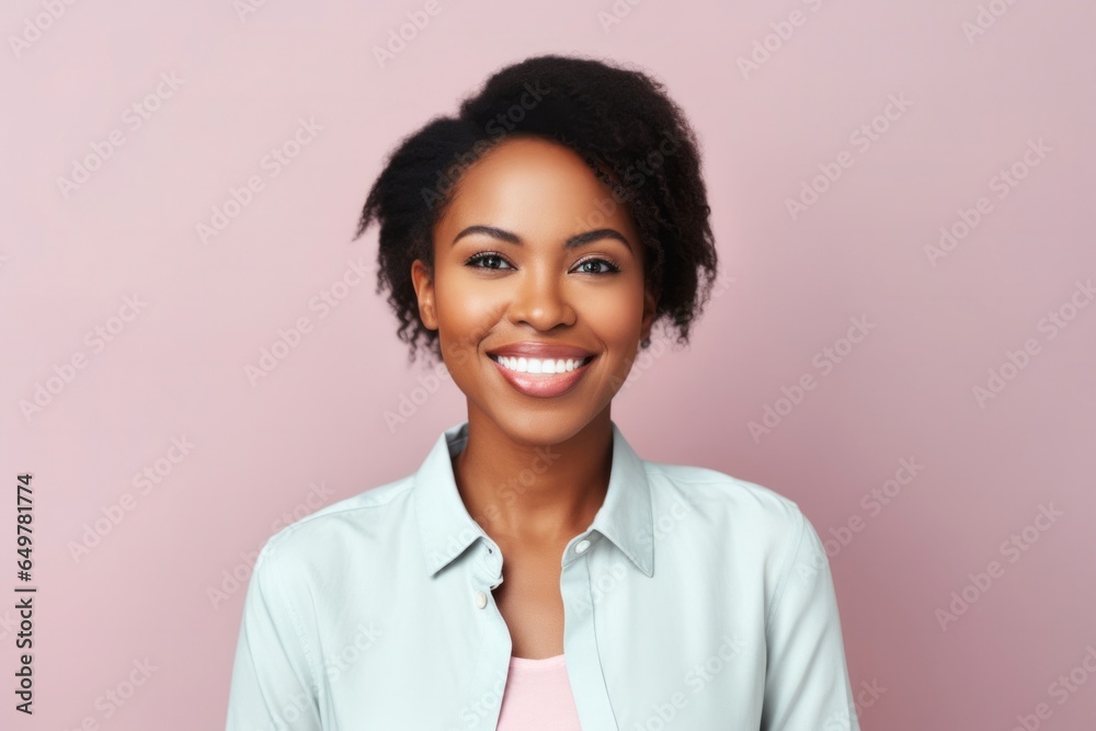 Cheerful woman with curly hair smiling at the camera on colored background Cheerful woman with curly hair smiling at the camera on colored background