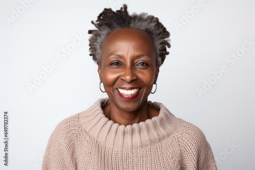 Cheerful individual with facial hair smiling in studio portrait