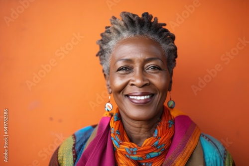 Obraz na płótnie Cheerful senior woman with colored background smiling w salonie