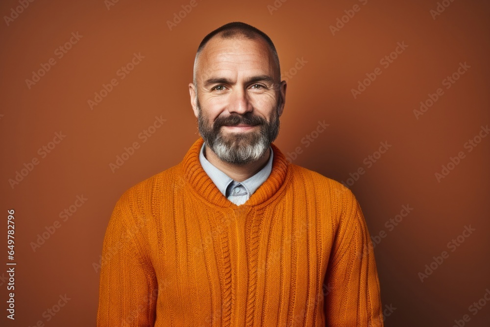 Confident mature man with a beard and casual clothing smiling happily