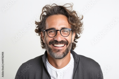 Confident smiling man with attractive beard and curly hair on white background © Eber Braun