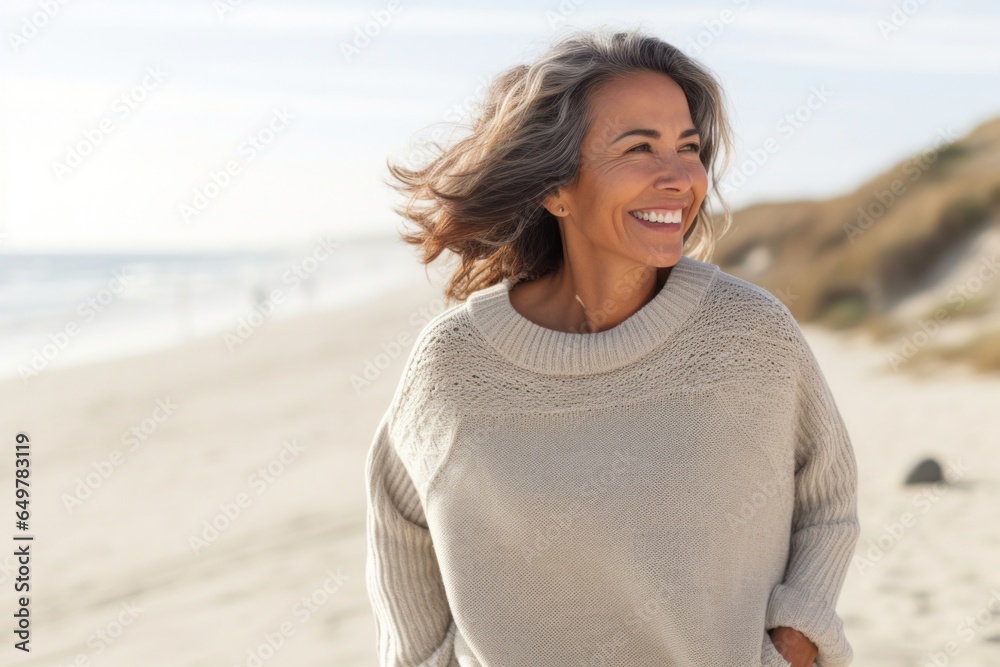 Woman smiling and enjoying a fun day at the beach on vacation Woman smiling and enjoying a fun day at the beach on vacation