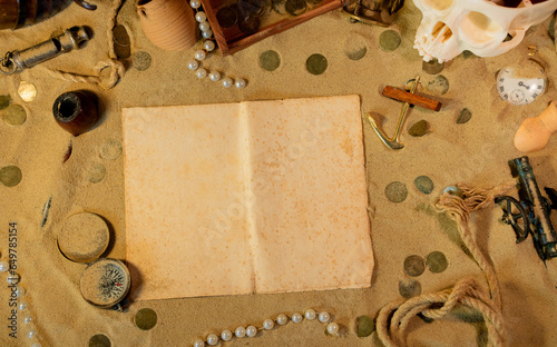 Treasure island theme. Vintge sheet of paper on the sand among shells, stones and marine elments. Frame on the sand background (ID: 649785154)
