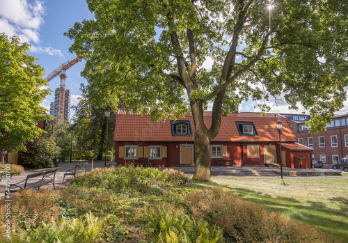 Old mansion red wood house, Stenbrottet and modern building apartments tower buildings Norr Tornen, an autumn day in Stockholm  photo