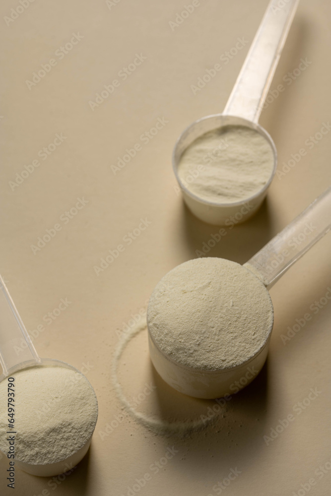 Protein powder in a measuring scoops, copy space Protein powder in a measuring scoops, copy space