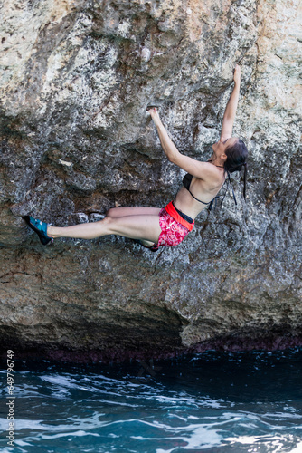 Women climbing. No rope, action sport. Excitement. 