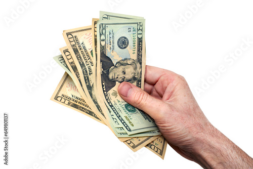 A hand holding, giving or paying American dollars in 10 and 20 banknotes, paper currency, isolated against a transparent background.
