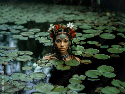 Brazilian indigenous woman surrounded by waterlilies photo