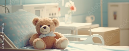 Banner with cute teddybear toy on patient bed at hospital. Health center or hospital room for young patient. Healthcare and childhood concept