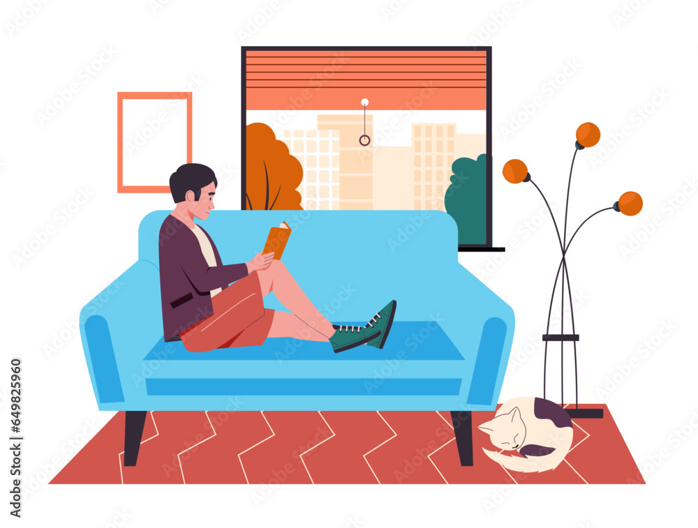 Man reading book on couch at home Man reading book on couch at home