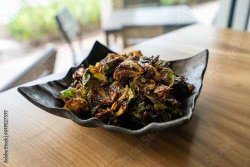 crispy and browned brussel sprouts appetizer at fine dining restaurant with seasoning