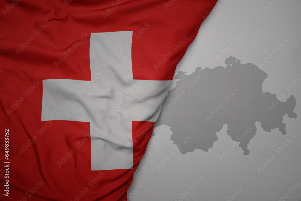 big waving national colorful flag and map of switzerland on the gray background. big waving national colorful flag and map of switzerland on the gray background.