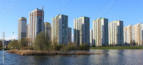 modern urban park with artificial lake and residential towers in front photo
