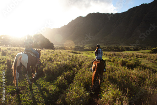 Fototapeta Naklejka Na Ścianę i Meble -  Riding at Kualo Aranch Park in Hawaii, where the sun sets