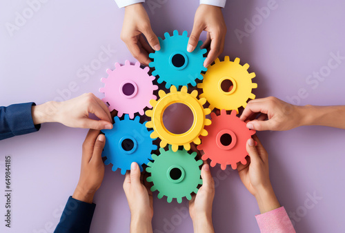Diveresity hands holding colorful gears, forming a unified mechanism. Cooperation and Interaction concept, Efficiency and Optimization