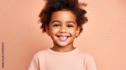 Multiracial child, cute and cheerful, on a soft studio background.