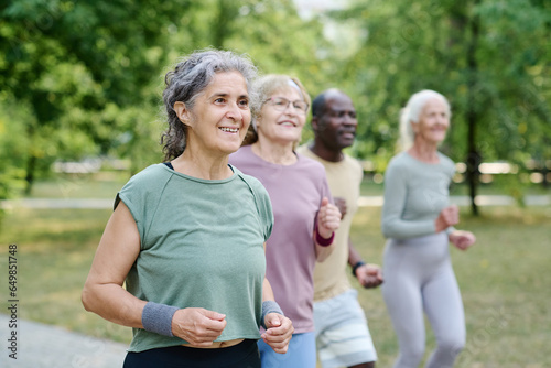 Group of senior people jogging together in the park outdoors