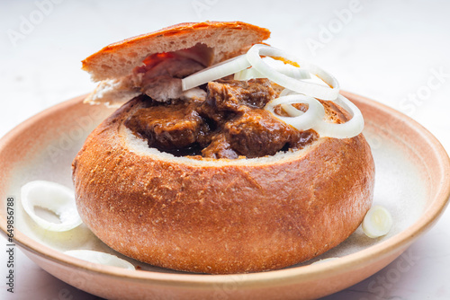 beef goulash in loaf of bread