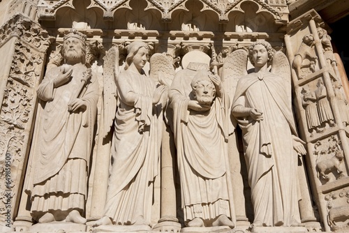 The Statues Around St. Denis Holding His Head At The Notre-Dame Cathedral; Paris, France photo