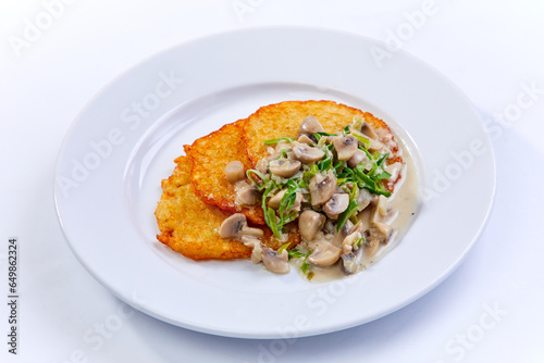 potato pancakes with sauce and mushrooms
