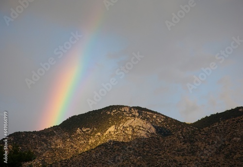 A Rainbow Over A Mountain Ridge; New Mexico, United States Of America