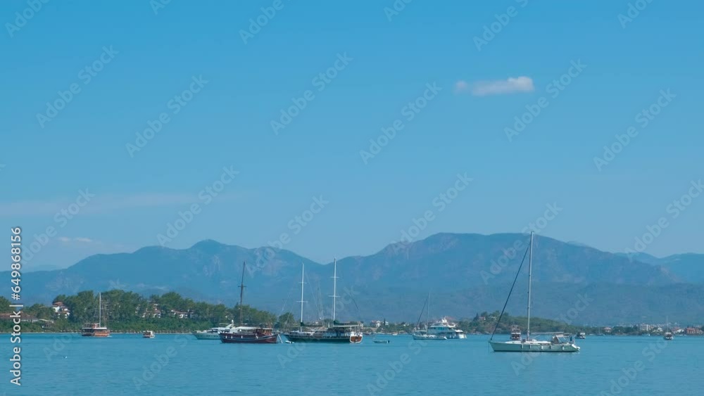 Boats slowly run on sea waves. A view of traveling boats sailing in the tropical bay during summer vacation. Boats slowly run on sea waves. A view of traveling boats sailing in the tropical bay during summer vacation.