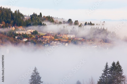 Houses On A Hill Through The Morning Fog; Happy Valley, Oregon, United States Of America