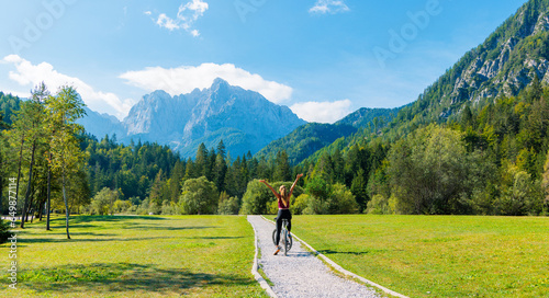 Woman on bike in Slovenia mountain landscape- sport,travel,adventure concept