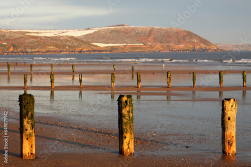Posts Along The Shoreline In Winter; Youghal Beach, East Cork, Ireland photo