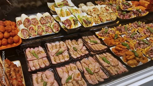 Street food on display at a market in Spain. Traditional and original delicious food behind glass at a market in Barcelona.
