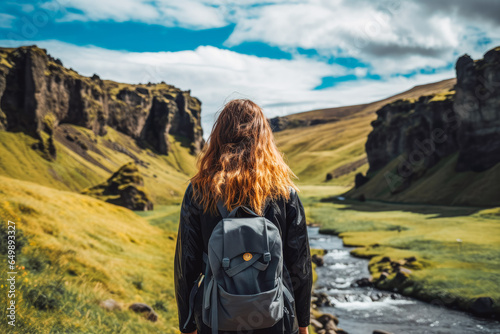 Woman traveling in Iceland in summer. Happy young traveler exploring in nature.