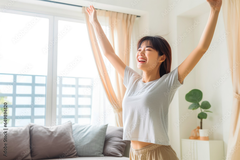 Positive chinese girl dancing at home. Happiness and well being concept. Positive chinese girl dancing at home. Happiness and well being concept.