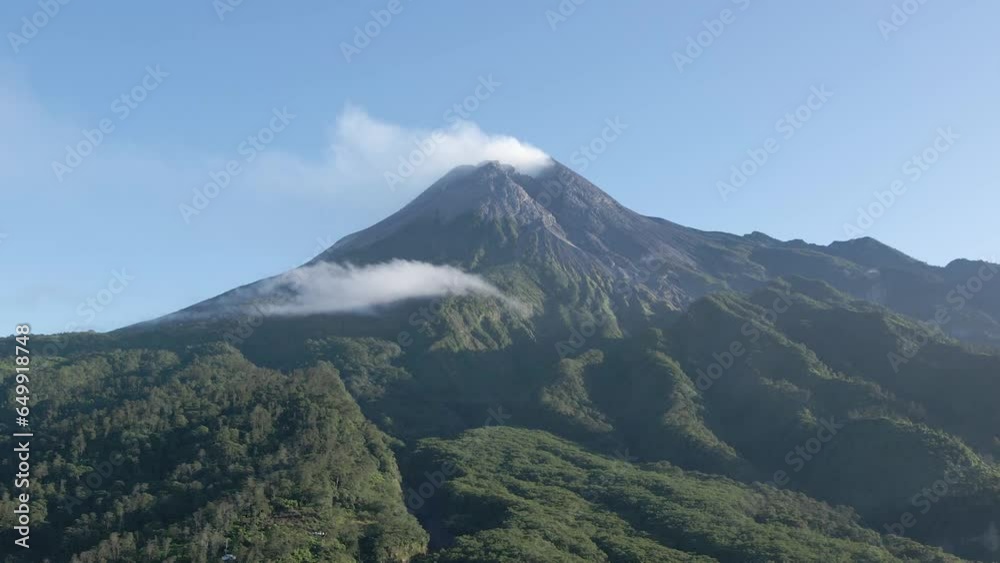 Stunning aerial view of Mount Merapi, a beautiful and peaceful active volcano. Beautiful wild natural views around the mountain in the form of dense forests, valleys and hills Stunning aerial view of Mount Merapi, a beautiful and peaceful active volcano. Beautiful wild natural views around the mountain in the form of dense forests, valleys and hills