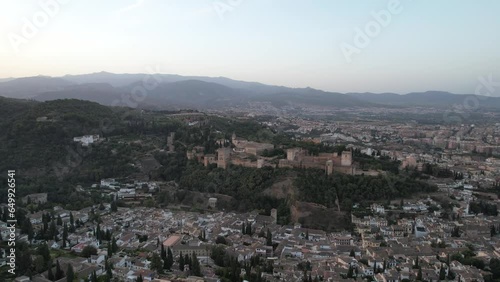 The Alhambra, perched majestically atop a hill in Granada, Spain, bathes in the ethereal beauty of a sunrise. This iconic Moorish palace and fortress complex is a UNESCO World Heritage site.
