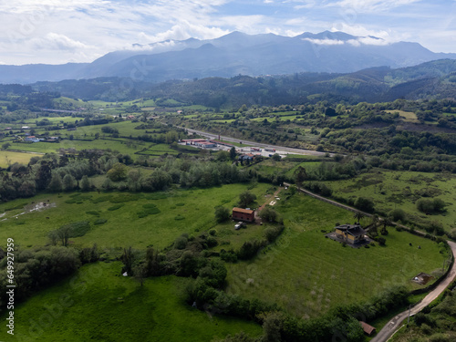 Travelling by car in Asturias, North of Spain. Aerial view on village, houses, gardens near Villaviciosa photo