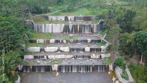 Aerial footage of the Watu Purbo sabo dam in Sleman, Indonesia which has a 6-level water dam. Apart from preventing the eruption of Mount Merapi, this dam is also a popular tourist destination photo