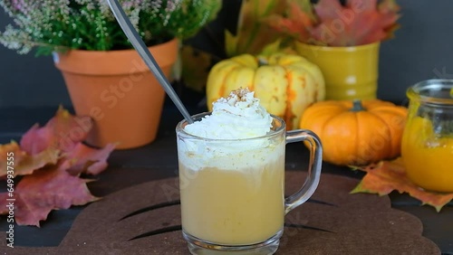 Pumpkin latte. Making a pumpkin latte. Autumn drink.