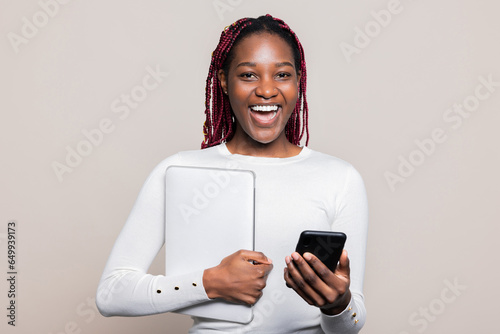 Happy African American girl lady milenial woman with cellphone in hands laptop ready to go to University Haigh school posing photo