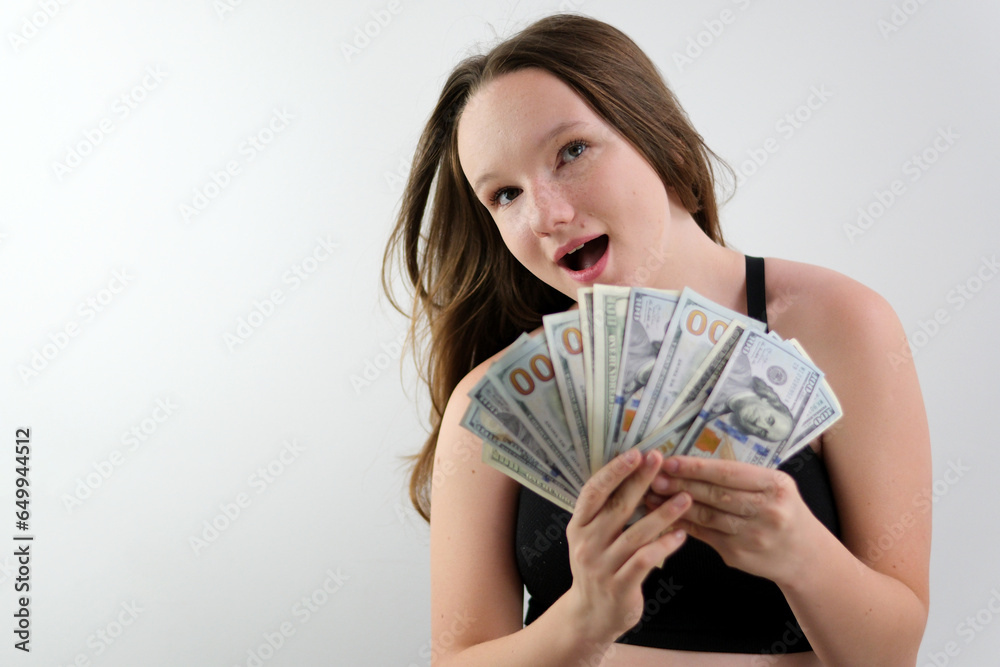 Young Happy Woman in gray sweater which holding money and looking at camera. High quality 4k footage Young Happy Woman in gray sweater which holding money and looking at camera. High quality 4k footage