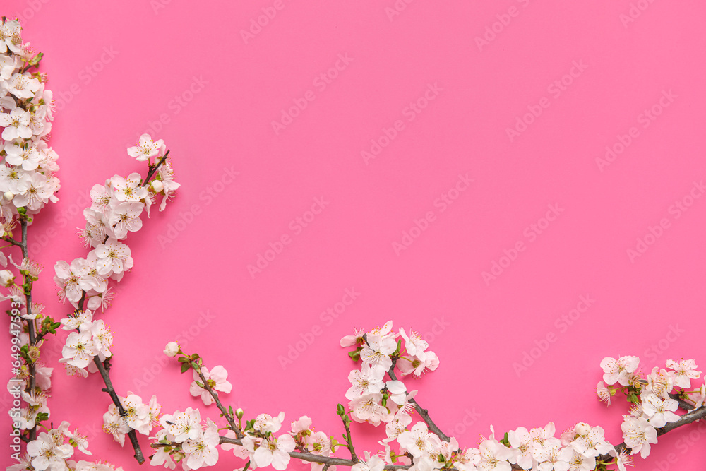Frame made of blooming branches on pink background