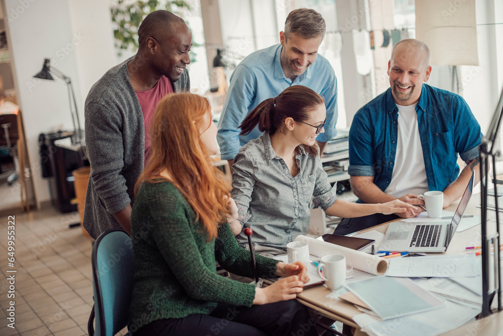 Diverse group of architects working on a project together in a modern company office Diverse group of architects working on a project together in a modern company office