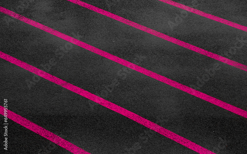 Pink paralel lines on dark wet asphalt