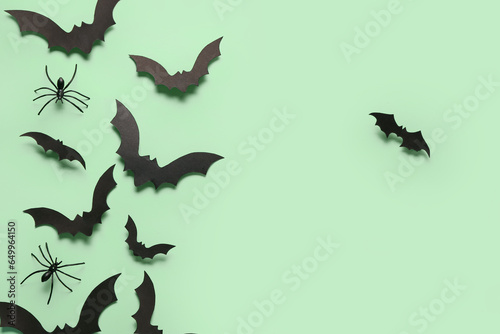 Paper bats and spiders for Halloween party on green background