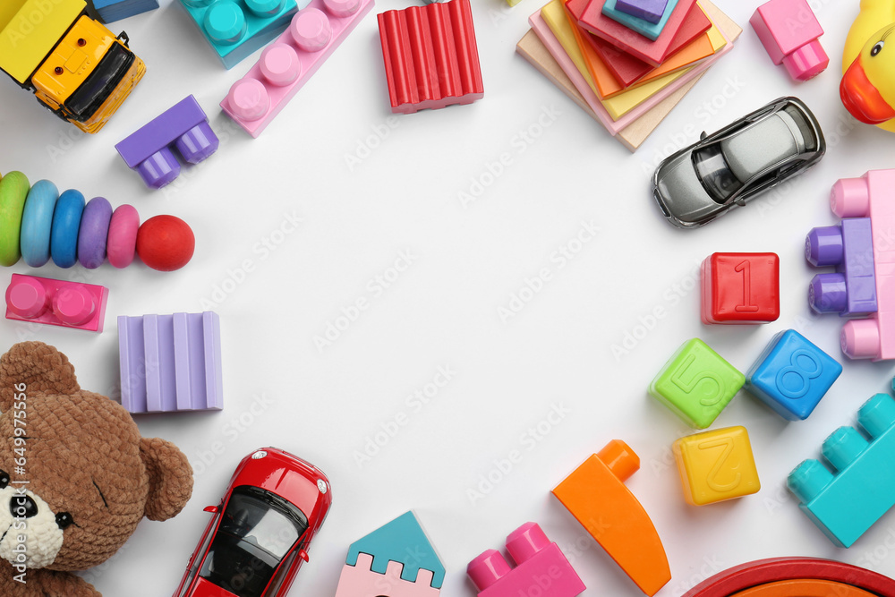 Frame of different children's toys on white background, flat lay. Space for text