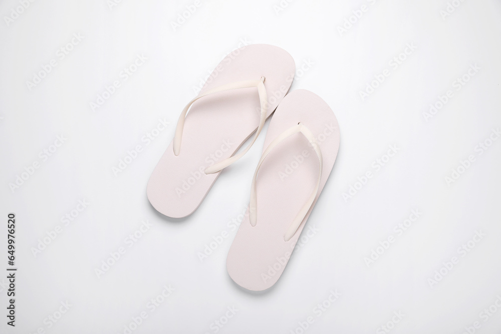 Stylish flip flops on white background, top view Stylish flip flops on white background, top view