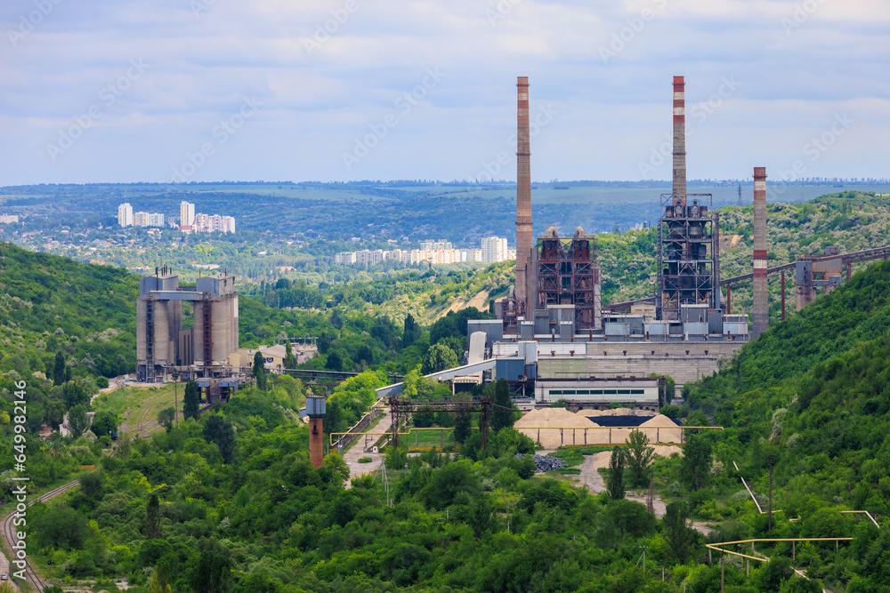 Plant or factory. Industrial area in a picturesque beautiful green area. Background with selective focus and copy space
