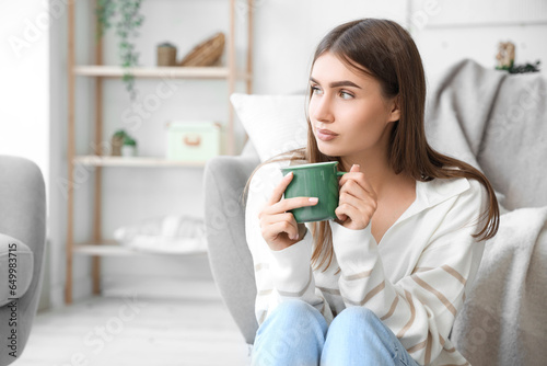 Young woman with cup of hot...